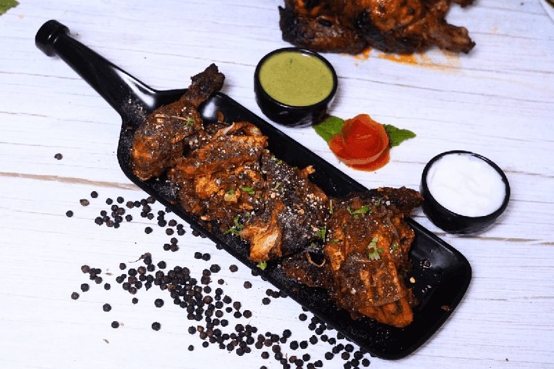 Freshly grilled tandoori chicken cooked in traditional clay oven